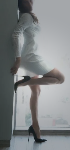 BKS in a white dress and black heels